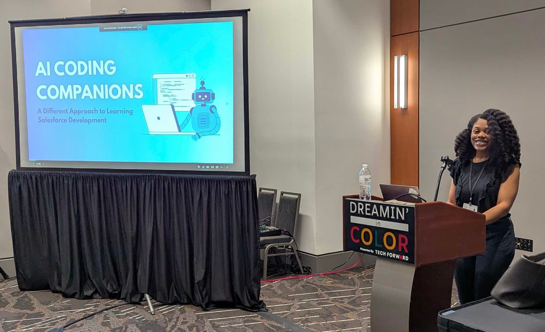 Kimberly Small presenting a technical session on stage.